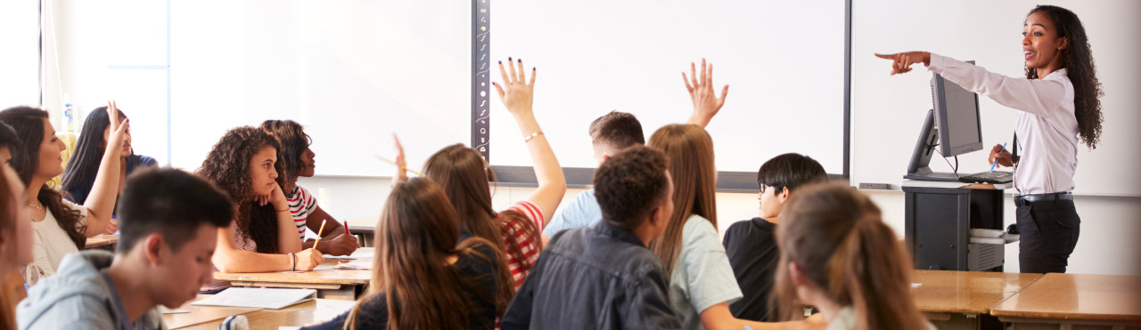 Teacher stands in front of class at a secondary school