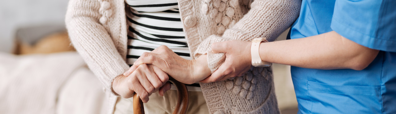 Older person is supported by a nurse