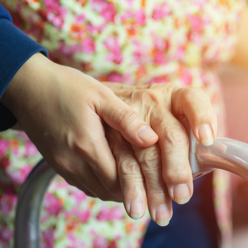 Hand of an elderly lady on a walker