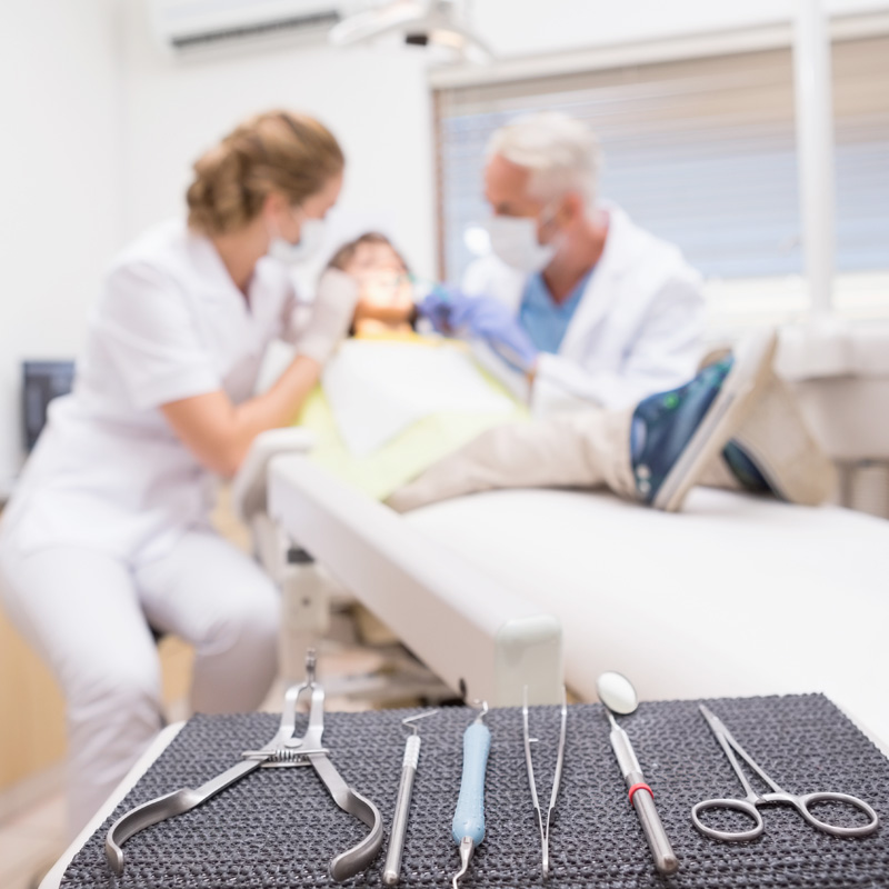 Dentist and assistant treat a young child