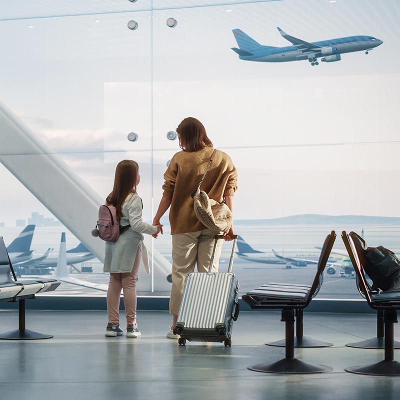 Mother and daughter wait for the plane at a clean airport.