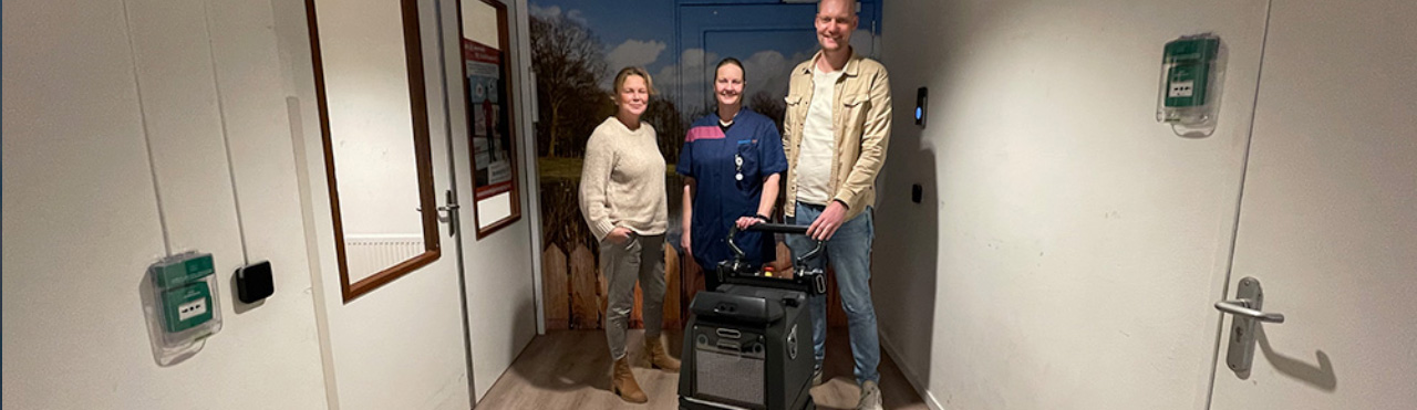 cleaning team working with a cleaning robot in a healthcare environment